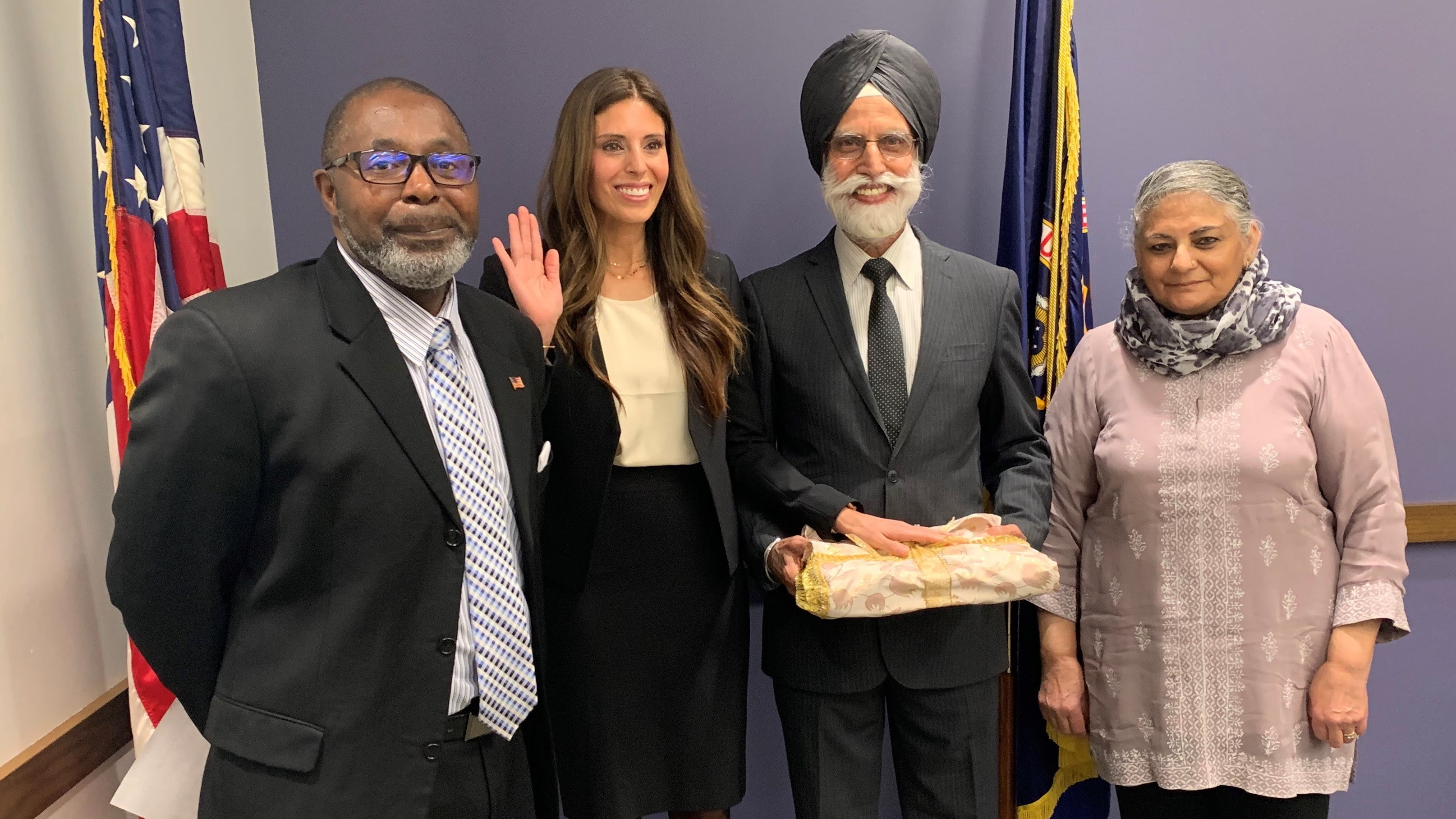 Amrith Kaur Aakre (second from left) poses during her swearing-in ceremony as the director of the EEOC’s Chicago District on Jan. 29, with Thomas Colclough, director of field management programs, and her parents Rajinder and Navinder Mago. 